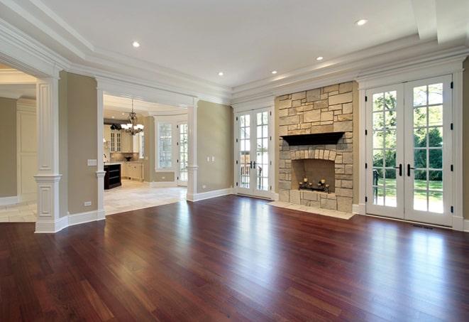 brightly lit room with shiny wood flooring